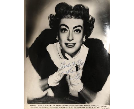 JOAN CRAWFORD. An 8x10" black and white photographic print signed in blue ink by Joan Crawford with inscription.