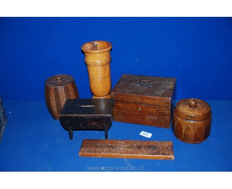 A box of Treen including lidded tea caddy, small table wooden money box, Biggs empire cribbage board, small wooden lined jewe