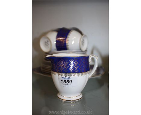 A pretty cobalt blue gilded Queen Anne part Teaset including four cups (some as found), a milk jug, six tea plates, six sauce