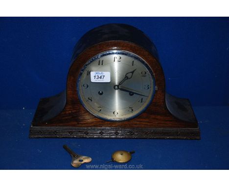 A Napoleon hat mantle clock with pendulum and key