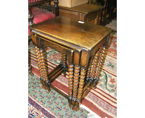 A reproduction Nest of three Oak Tables on bobbin turned legs with stretchers