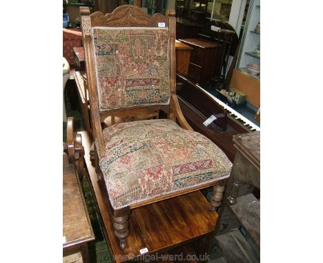 A Victorian Beech show frame Parlour easy Chair having carved top rail and back supports, on turned legs with castors, button