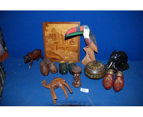 A quantity of wooden animals including camels, a wooden elephant, three pairs of small wooden clogs, an egg timer, etc