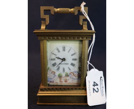 Miniature brass carriage clock with painted porcelain Roman face and figural porcelain side panels. 9cm high approx.(B.P. 24%