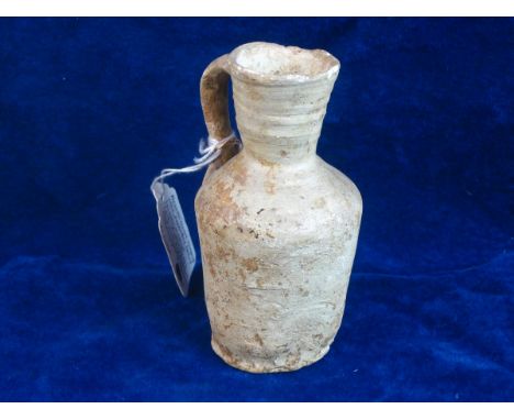 MESOPOTAMIAN JUG 1939 SOTHEBYS LABEL.   Measuring 4 ½ inches tall a simple jug believed to be of Mesopotamian origin retainin