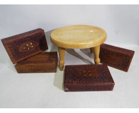 A child's vintage stool with carved decoration to the seat and four carved trinket / jewellery boxes with carved and inlaid d