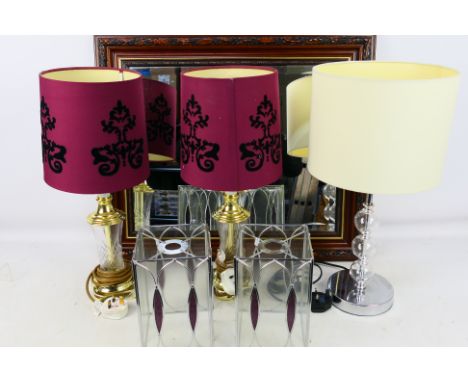 3 x Table lamps, 2 x stained glass lamp shades and a bevel edged wall mirror in a wooden frame approximately 55 cm x 65 cm. 