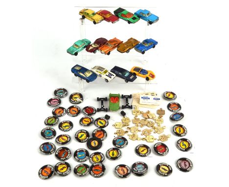 Fourteen Corgi Rockets die-cast vehicles with original keys (un-boxed) and a quantity of Mattel Hot Wheels tin badges.  (qty)