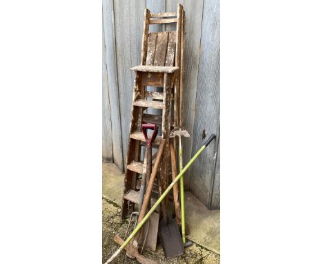 Two vintage wooden stepladders, together with several , long handled tools 