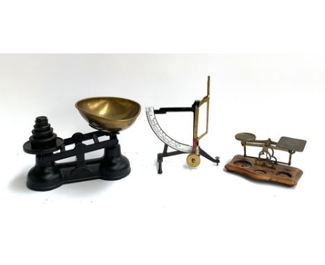A set of kitchen scales with weights; a quadrant balance and a set of postal scales (sans weights) 