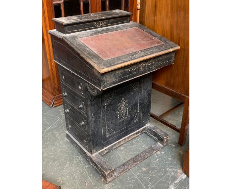 A 19th century ebonised davenport desk, with superstructure and hinged writing surface, carved with urn motifs, having four d