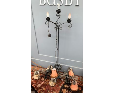 A wrought iron three arm standard lamp, together with two wrought iron hanging chandeliers 