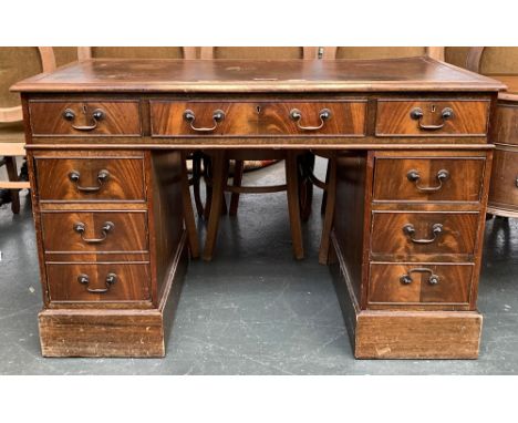 A 20th century oak pedestal desk, leather inset top over nine drawers, on plinth base, 121x61x77cmH 