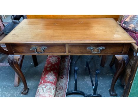 A mahogany side table in George II style, moulded top over two frieze drawers, on acanthus capped cabriole legs with ball and