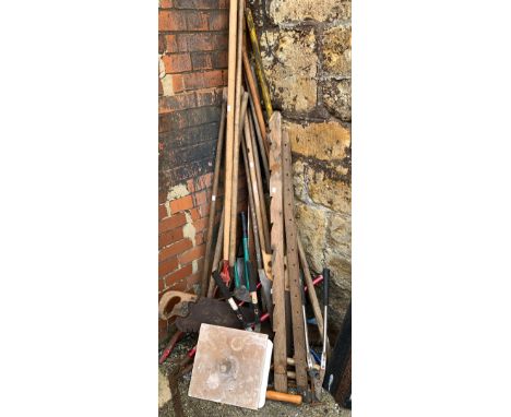 A large lot of various long handled and other garden tools 