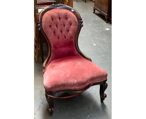 A Victorian button back salon chair with serpentine front and carved cabriole legs 