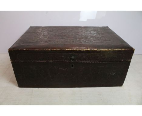 Early 20th century leatherette twin-handled trunk, embossed with flowers and foliage, 26cm high x 65,5cm wide x 44cm deep 