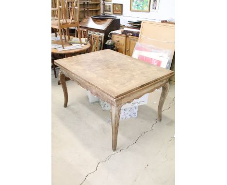 Continental style oak draw leaf, extending dining table, with parquetry design, shaped apron on carved cabriole legs, 77cm hi