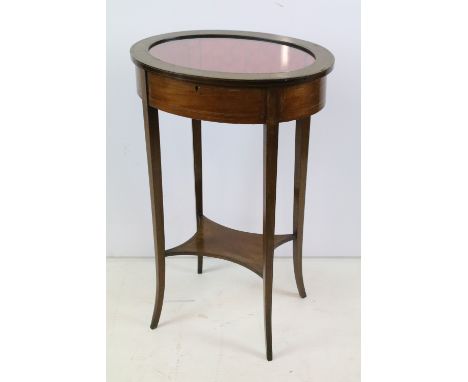 Edwardian mahogany inlaid oval bijouterie table, with glazed top above stretchered panel, 75.5cm high x 49cm wide x 37cm deep