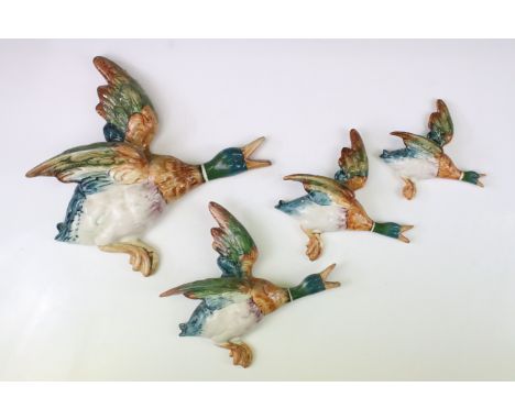 Set of four Beswick graduating duck ceramic wall plaques, model no.s 596-0, 596-2, 596-3 (a/f) &amp; 596-4, largest approx 30