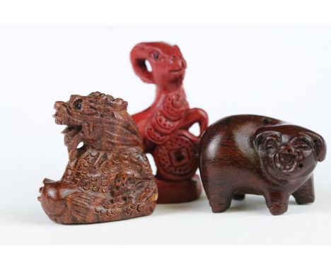 Three carved wooden miniature netsuke figures to include signed Pig, Money Goat and a Dragon 