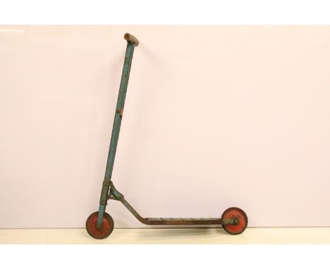 Vintage metal and wood ride on scooter in the Triang style, blue body, wood handles and red hubs, shows rust 