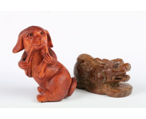 Two carved wooden netsuke figures to include a signed Dog chewing toy, and a Money Dragon on Coin, tallest 7cm 