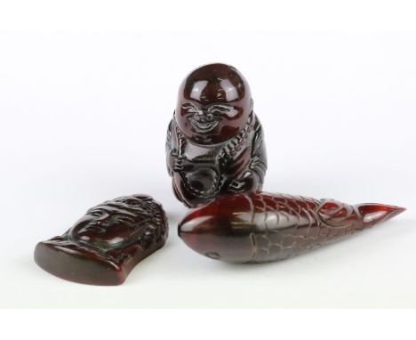 Three carved netsuke toggles to include a Happy Buddha, Koi Fish and Buddha head, largest measures 7cm 