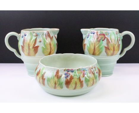 Clarice Cliff for Newport Pottery - Pair of leaf &amp; berry pattern molded jugs on a celadon type ground (approx 19.5cm tall