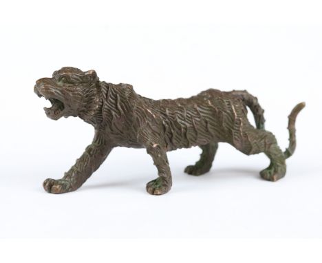 A Chinese bronze ornament in the form of a tiger. 