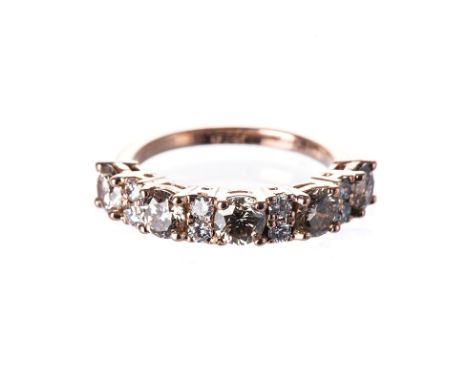 A DIAMOND HALF-ETERNITY RING claw-set to the centre with eight cognac-coloured round brilliant-cut diamonds weighing approxim