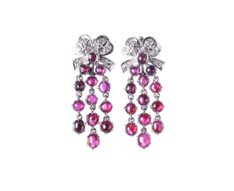 RUBY AND DIAMOND EARRINGS Each surmount designed as a bow highlighted with round brilliant-cut diamonds, suspending three art