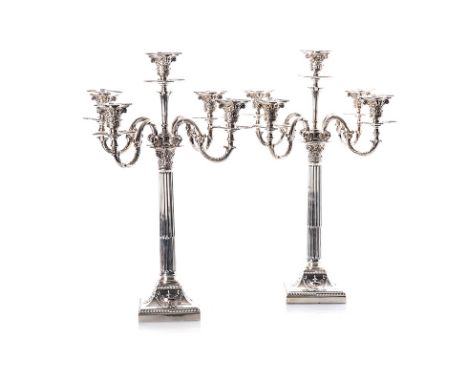 A PAIR OF SILVER FIVE-LIGHT CORINTHIAN COLUMN CANDELABRA, ELKINGTON & CO, BIRMINGHAM, VARIOUS DATES 1906, 1920 & 1921 the squ