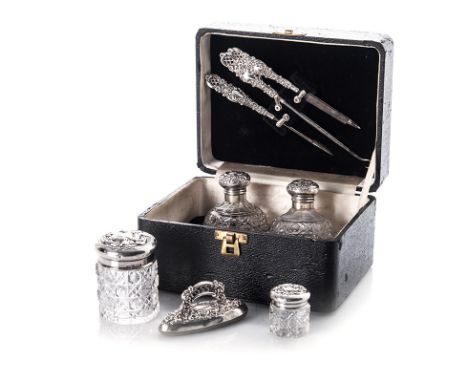 AN EDWARDIAN SILVER CASED DRESSING TABLE AND MANICURE SET, LEVI & SALAMAN, BIRMINGHAM, 1902 comprising: two globular cut-glas