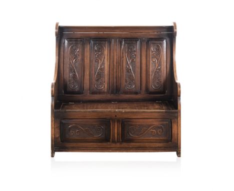 A FRUITWOOD MONKS BENCH, 19TH CENTURY the reeded top rail above four foliate carved panels between shaped supports, hinged ha