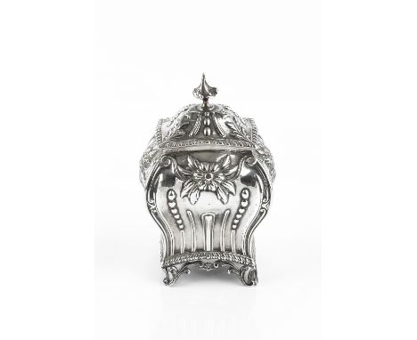 AN EDWARDIAN SILVER TEA CADDY AND COVER, of shaped rectangular baluster form, repoussé decorated in the Art Nouveau style wit