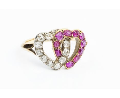 A RUBY AND DIAMOND DOUBLE HEARTS RING, designed as two openwork entwined hearts, set with cushion-shaped old and rose-cut dia