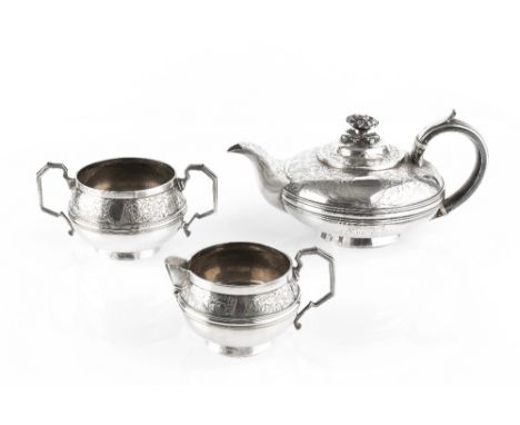 A GEORGE IV SILVER TEAPOT, of compressed circular form, engraved with scrolling foliage, and with flower finial, the handle w