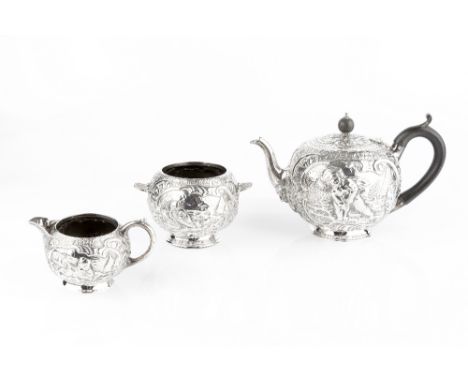 A VICTORIAN SILVER THREE PIECE TEA SERVICE, of globular form, repoussé decorated with cherubs and stylised scrolling foliage,