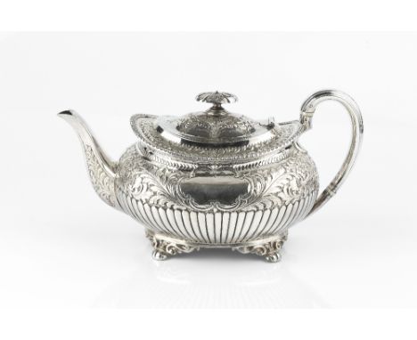 A LATE VICTORIAN SILVER TEAPOT, the half lobed body embossed and engraved with stylised flowering foliage, having gadrooned b