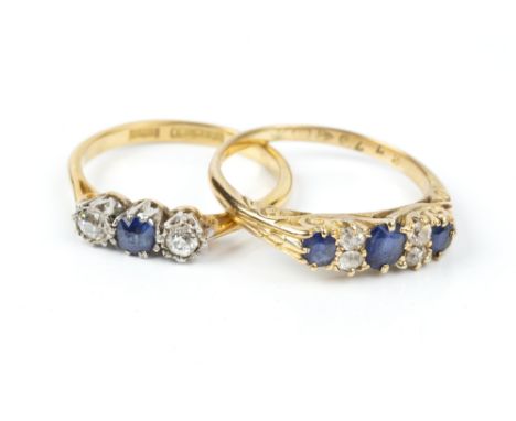 A SAPPHIRE AND DIAMOND HALF HOOP RING, the scroll engraved hoop set with three oval mixed-cut sapphires, spaced by pairs of o