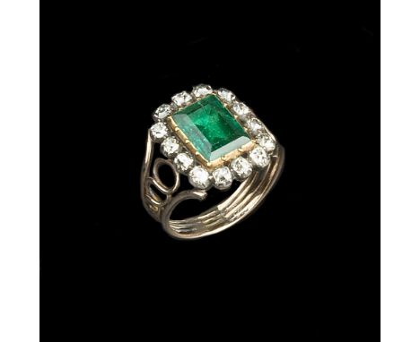 A 19TH CENTURY EMERALD AND DIAMOND PANEL RING, the rectangular step-cut emerald in foiled closed-back and pinched collet sett