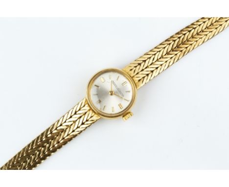 A LADY'S 18CT GOLD BRACELET WATCH BY JAEGER-LECOULTRE, the circular silvered dial with gilt baton markers, to a jewelled manu