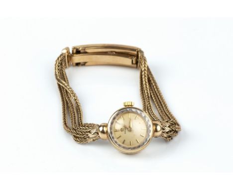 A LADY'S 9CT GOLD BRACELET WATCH BY OMEGA, the circular silvered dial with baton markers, to a jewelled manual wind calibre 4