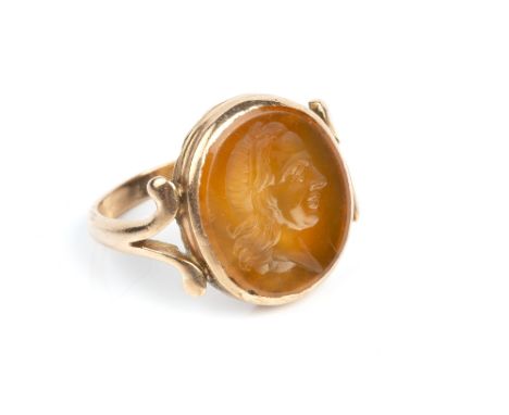 A 19TH CENTURY HARDSTONE INTAGLIO RING, the oval panel incised with a classical male portrait profile, to a fluted closed-bac