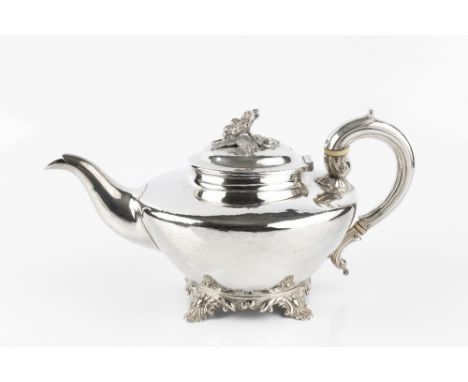 A WILLIAM IV SILVER TEAPOT, with compressed circular body, scroll handle, and foliate scroll cast foot, and with flower finia