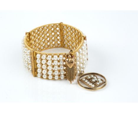 A RUBY AND FRESHWATER PEARL BANGLE/BRACELET, designed as a series of articulated panels, each set with five rows of freshwate
