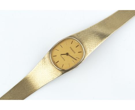 A LADY'S 9CT GOLD BRACELET WATCH BY TISSOT, the oval dial with baton markers, to a quartz movement and tapered bracelet, case