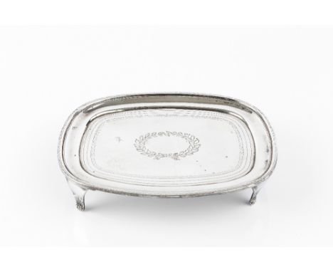 A GEORGE III SILVER TEAPOT STAND, of rounded rectangular form, with engraved wrigglework borders and central foliate wreath, 