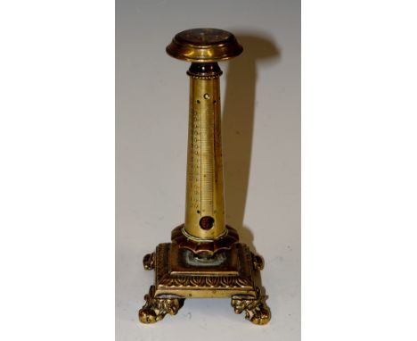 A brass columnar thermometer topped with compass, detailed base and feet, inscribed with temperature -20 to 120, 13cm high, 6